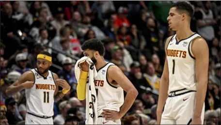  ?? AARON ONTIVEROZ — THE DENVER POST ?? Denver’s Bruce Brown (11), Jamal Murray (27) and Michael Porter Jr. (1) take a breather during the fourth quarter of the Detroit Pistons’ 110-108 win at Ball Arena on Tuesday night.