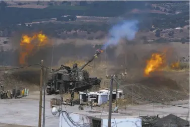  ?? Ayal Margolin / JINIPIX ?? Israeli forces fire artillery from their position on the border with Lebanon after a barrage of rockets were launched by Hezbollah militants at Israel. Hezbollah, which is backed by Iran, is based in Lebanon.