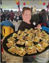  ?? CONTRIBUTE­D ?? Operations Director Jeremie Foley, serving a tray of Crab Cakes.