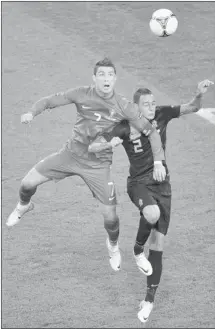  ?? Sergei Supinsky, Afp-getty Images ?? Portuguese forward Cristiano Ronaldo, left, vies with Dutch defender Gregory van der Wiel on Sunday. Ronaldo scored twice in a 2-1 win.