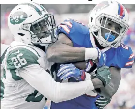  ??  ?? HAVING HIS WAY: Bills running back LeSean McCoy (right), who rushed for 110 yards on 22 carries, fights off Jets safety Marcus Maye during Buffalo’s win Sunday.