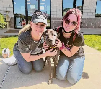  ?? Conroe Animal Shelter ?? Angela Surrett, left, her dog, Vader, and daughter, Marti, reunite on April 7 in front of the Conroe Animal Shelter. The Surretts had not seen Vader since 2011.