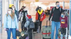  ?? DAVID ZALUBOWSKI/AP ?? Travelers check in at a ticket counter Dec. 31 at Denver Internatio­nal Airport.