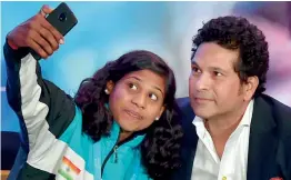  ?? — PTI ?? Karate champion Mana Mandlekar takes a selfie with cricket legend Sachin Tendulkar after a panel discussion on “the role of sports in the empowermen­t of girls” in New Delhi on Wednesday.