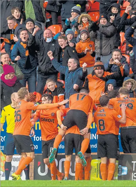  ??  ?? PARTY TIME: Jubilant Dundee United players celebrate in front of their fans after Paul Paton’s winning goal on Saturday