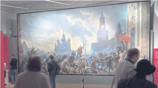  ??  ?? ARTIST’S TAKE: People walk past the ‘Assault of the Moscow’s Kremlin’ painting of Pavel Sokolov-Skalia at an exhibition in Moscow this month.