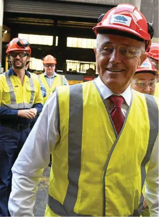  ?? PHOTO: DEAN LEWINS/AAP ?? MAN OF STEEL: With Australia having secured an exemption from US tariffs on steel and aluminium, Malcolm Turnbull meets steel workers in Wollongong yesterday.