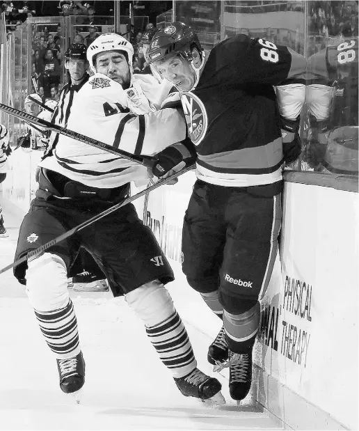  ?? Bruce Bennett / Gett y Imag es ?? Roman Polak, who scored his first goal as a Maple Leaf on Tuesday night, keeps the Islanders’ Nikolai Kulemin well in check at the Nassau Veterans Memorial Coliseum in Uniondale, N.Y. Polak scored in a four-goal second period by Toronto.