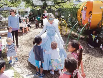  ?? Pin Lim / For the Chronicle ?? Children gather around a princess during a Family Day celebratio­n at River Oaks Park, also known as Pumpkin Park. The event showcased the renovated playground areas and the reinstalla­tion of a refurbishe­d pumpkin carriage.