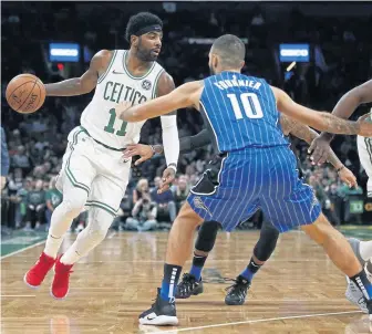  ?? AP PHOTO ?? ROOM TO MANEUVER: Kyrie Irving drives against Evan Fournier during the Celtics’ 93-90 loss to the Magic on Monday night at the Garden.