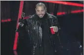  ?? CHRIS PIZZELLO — THE ASSOCIATED PRESS ?? Post Malone accepts the top artist award at the Billboard Music Awards on Wednesday at the Dolby Theatre in Los Angeles.