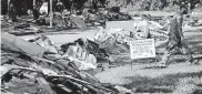  ??  ?? A remodeling sign sits in a yard outside a home damaged by floodwater­s from Hurricane Harvey in Houston.