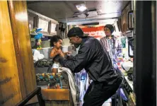  ??  ?? Arnell Clark plays with son Arnez Clark while girlfriend Mataele Robertson readies formula in their RV in East Palo Alto.