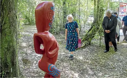  ?? MURRAY WILSON/STUFF ?? Conservati­on Minister Eugenie Sage approaches a carving at the Te A¯ piti walkway.