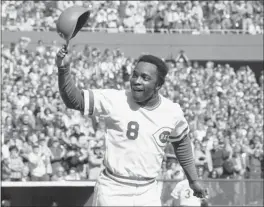  ?? THE ASSOCIATED PRESS — 1976 ?? Cincinnati second baseman Joe Morgan tips his helmet to the fans as he rounds the bases after a homer against the New York Yankees at Riverfront Stadium.