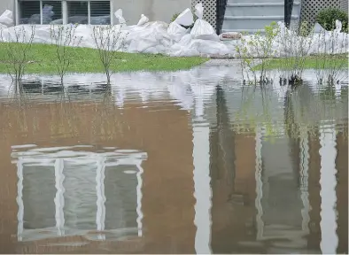  ?? GRAHAM HUGHES/THE CANADIAN PRESS ?? Sandbags protect a house in Vaudreuil-Dorion last week. Mayor Guy Pilon said the city’s new emergency measures plan allowed authoritie­s to quickly alert residents who were at risk.