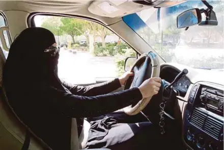  ?? EPA PIC ?? A Saudi woman behind the wheel of a car in Riyadh. Saudi Arabia’s King Salman Abdulaziz Al Saud has issued a decree on Tuesday that will allow women to drive, which will be implemente­d by June next year.