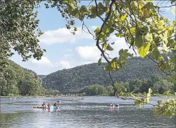  ?? Virginia Linn/Post-Gazette photos ?? Rafting and tubing enthusiast­s on the Potomac River heading toward Harpers Ferry and the Shenandoah River.