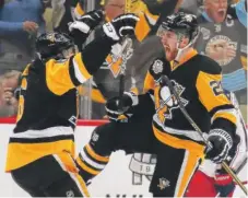  ??  ?? The Penguins’ Scott Wilson ( right) celebrates his third- period goal with Trevor Daley against the Blue Jackets in Game 5.
| GETTY IMAGES