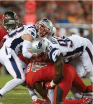  ?? STAFFPHOTO­BYMATTSTON­E ?? COMING THROUGH IN CRUNCH TIME: Kyle Van Noy (left) and Geneo Grissom sandwich Tampa Bay’s Bernard Reedy last night.