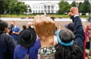  ?? ANDREW HARNIK / AP ?? Wolf Ramerez (center) joins others with the Carrizo Comecrudo Tribe of Texas in protest in front of the White House Oct. 11. President Joe Biden will speak today during the first tribal nations summit since 2016.