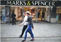  ??  ?? PEOPLE walk past a branch of British retailer Marks & Spencer in the British overseas territory of Gibraltar, historical­ly claimed by Spain, April 20.