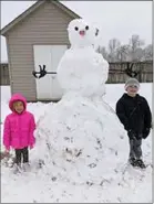  ?? Photograph courtesy of Sheri Trevathan ?? The grandchild­ren of Kevin and Sheri Trevathan built a tall snowman.