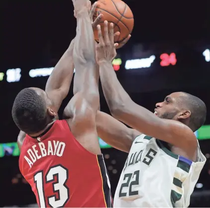  ?? SLADKY/ASSOCIATED PRESS LYNNE ?? Khris Middleton, right, and the rest of the Bucks had a rough shooting performanc­e against the Heat on Sunday.