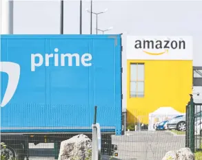  ?? DENIS CHARLET / AFP VIA GETTY IMAGES ?? Amazon.com Inc. is working to keep its e-commerce operations running as the coronaviru­s pandemic sickens employees and disrupts supply chains.