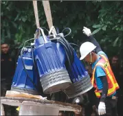  ?? Associated Press photo ?? Pumps are moved from a truck to be used to help drain the rising flood water in a cave where 12 boys and their soccer coach have been trapped since June 23, in Mae Sai, Chiang Rai province, in northern Thailand Friday.