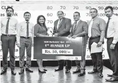  ??  ?? First Runner-up: AMW Capital Leasing and Finance PLC receives the award and prize from chief guest Lanka Hospitals PLC Group Chief Executive Officer Dr. Prasad Medawatte and SLIM President Pradeep Edward