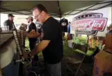  ?? THE DAILY RECORD VIA AP ?? In a photo, Chuck Aaron, president and CEO of Jersey Girl Brewing Co., works at New Jersey’s only all New Jersey Craft Beer and Food Festival at Lewis Morris Park in Morristown, N.J., as a fundraiser for Eleventh Hour Rescue, a Rockaway-based animal...