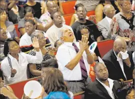  ?? Paul Zoeller Pool Photo ?? WORSHIPERS FILL the Emanuel AME Church in Charleston, S. C. Hundreds more stood outside, listening to the Sunday service via loudspeake­rs.