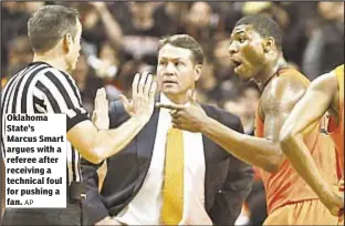  ?? AP ?? Oklahoma State’s Marcus Smart argues with a referee after receiving a technical foul for pushing a fan.