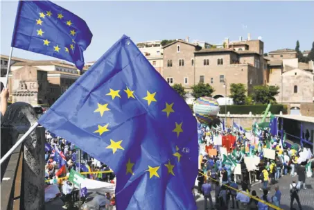  ?? Vincenzo Pinto / AFP / Getty Images ?? Pro-Europe demonstrat­ors gather in Rome under European Union flags to express their support for the alliance.