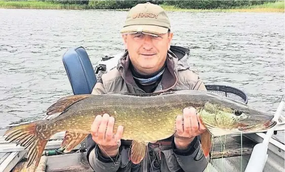  ??  ?? What a whopper Gary Johnson landed this fine pike at Lake of Menteith