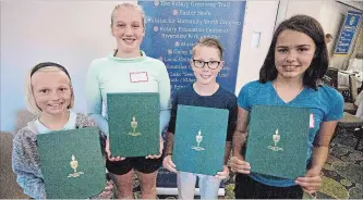  ?? JASON BAIN EXAMINER ?? Winners of the Rotary Club of Peterborou­gh 2018 Canada Day Essay Challenge, including, from left, Amealia Beaton, Lilly Fenton, Ryder Adair and Reilly Bates, pose after reading their creations to Rotarianso­n Monday.