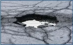  ?? ?? Pothole-ridden roads are commonplac­e across Scotland