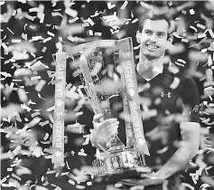  ??  ?? This file photo shows Britain’s Andy Murray celebratin­g with the trophy after winning the men’s singles final on the eighth and final day of the ATP WorldTour Finals tennis tournament in London. — AFP photo