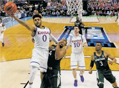  ?? SUE OGROCKI/ASSOCIATED PRESS FILE PHOTO ?? Kansas guard Frank Mason III shoots in front of Michigan State forward Nick Ward Sunday during an NCAA Tournament in Tulsa, Okla. Mason and Kansas will face off against the fourth-seeded Purdue Boilermake­rs on Thursday in Kansas City, Mo.