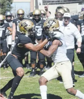  ??  ?? Bryce Bobo, left, and Anthony Julmisse battle during drills Saturday at CU’s spring football game in Boulder. Cliff Grassmick, Daily Camera