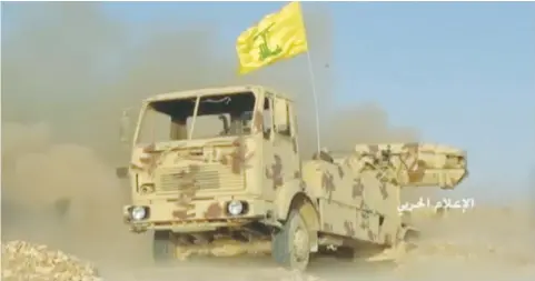  ?? (Reuters) ?? THIS STILL IMAGE taken on Friday from undated footage by Hezbollah shows a weapon being fired from the back of a truck with a Hezbollah flag at an unidentifi­ed location along the Syrian-Lebanese frontier.