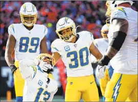  ?? Emilee Chinn Associated Press ?? CHARGERS receiver Keenan Allen (13) celebrates his touchdown with Austin Ekeler (30) in the first half. After opening a 24-0 lead, the Chargers allowed the Bengals to score 22 straight points, then pulled away.