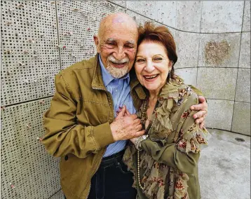  ?? REED SAXON / AP ?? Holocaust survivors Simon Gronowski and Alice Gerstel Weit hug last week at the Los Angeles Holocaust Museum memorial. The two old friends held hands tightly while sharing memories of a painful past.