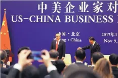  ?? ANDREW HARNIK/ASSOCIATED PRESS ?? U.S. President Donald Trump and Chinese President Xi Jinping attend a business event at the Great Hall of the People in Beijing on Nov. 9, 2017.