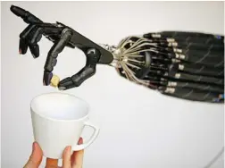  ?? JEFF J MITCHELL/ GETTY IMAGES FILES ?? Since the most advanced robot hand in the world was unveiled in London in 2008, above, software advances have made it possible to design vehicles that drive themselves and automated housekeepi­ng functions in hospitals.