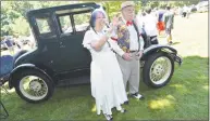  ?? Alex von Kleydorff / Hearst Connecticu­t Media ?? Norwalk’s Don and Peggy Morey, dressed in period clothes, wave to friends in front of their 1926 Ford Model T coupe at Mathews Park in Norwalk on Sunday.