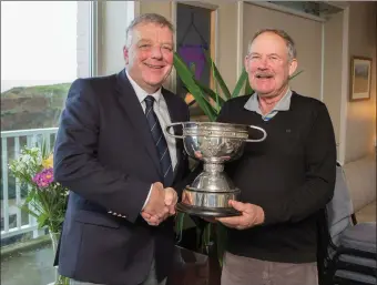  ??  ?? Blainroe Golf Club captain Peter Burgess presents Michael Kinsella with the Collins Cup trophy for 2018 at the recent AGM.