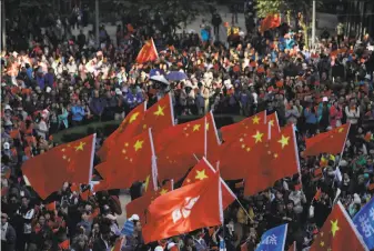  ?? Mark Schiefelbe­in / Associated Press ?? ProBeijing demonstrat­ors wave Chinese national flags during a rally in Hong Kong. Participan­ts assailed what they say is a reign of terror imposed by antigovern­ment protesters.