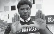  ?? DAVID FURONES/SUN SENTINEL ?? Miami running back commit Donald Chaney Jr. flashes “The U” after he received his All-American Bowl jersey at his high school, Miami Belen, on Friday.